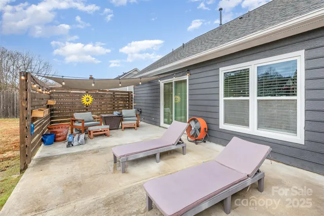 an outdoor sitting area with couch and umbrella