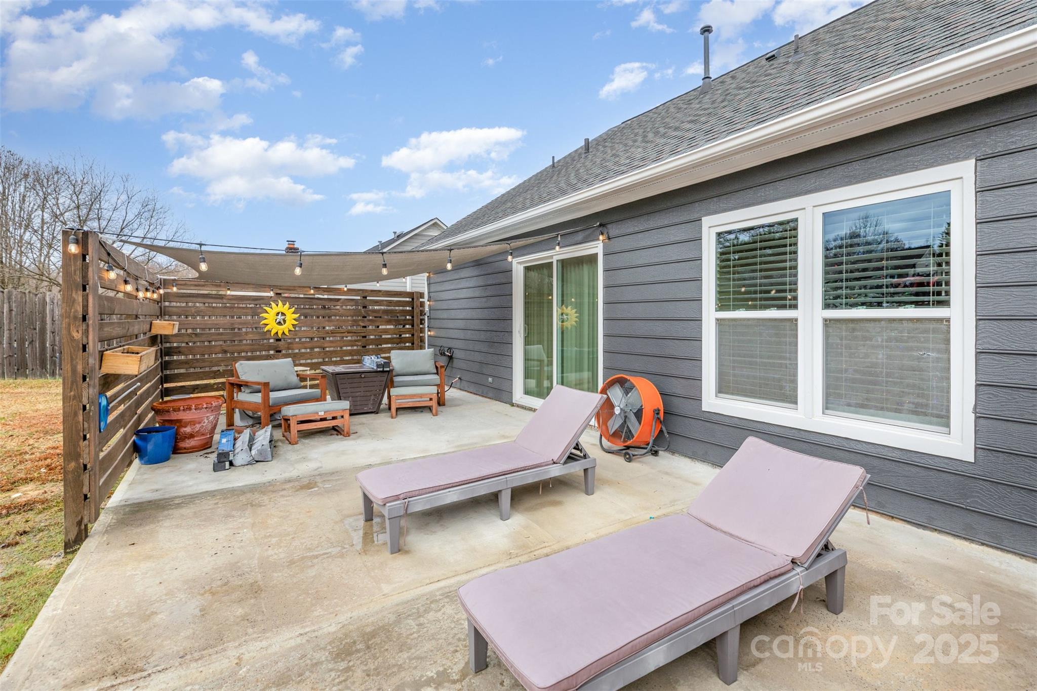 2241 Indian Cross Trail Matthews, NC 28104 - Photo 19 of 46 a backyard of a house with dining table and chairs