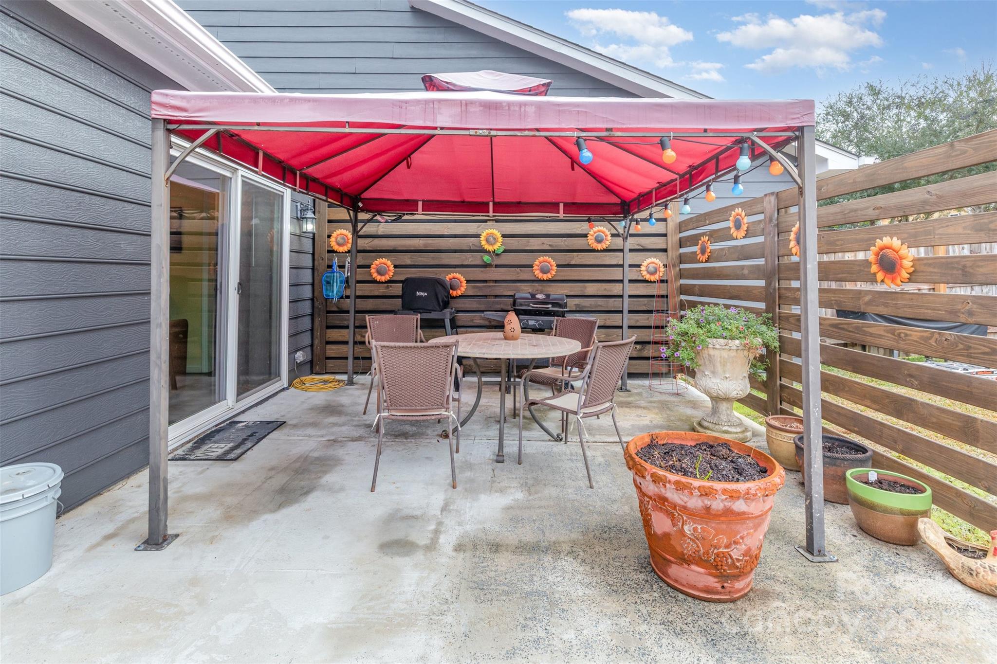 2241 Indian Cross Trail Matthews, NC 28104 - Photo 20 of 46 an outdoor sitting area with couch and umbrella