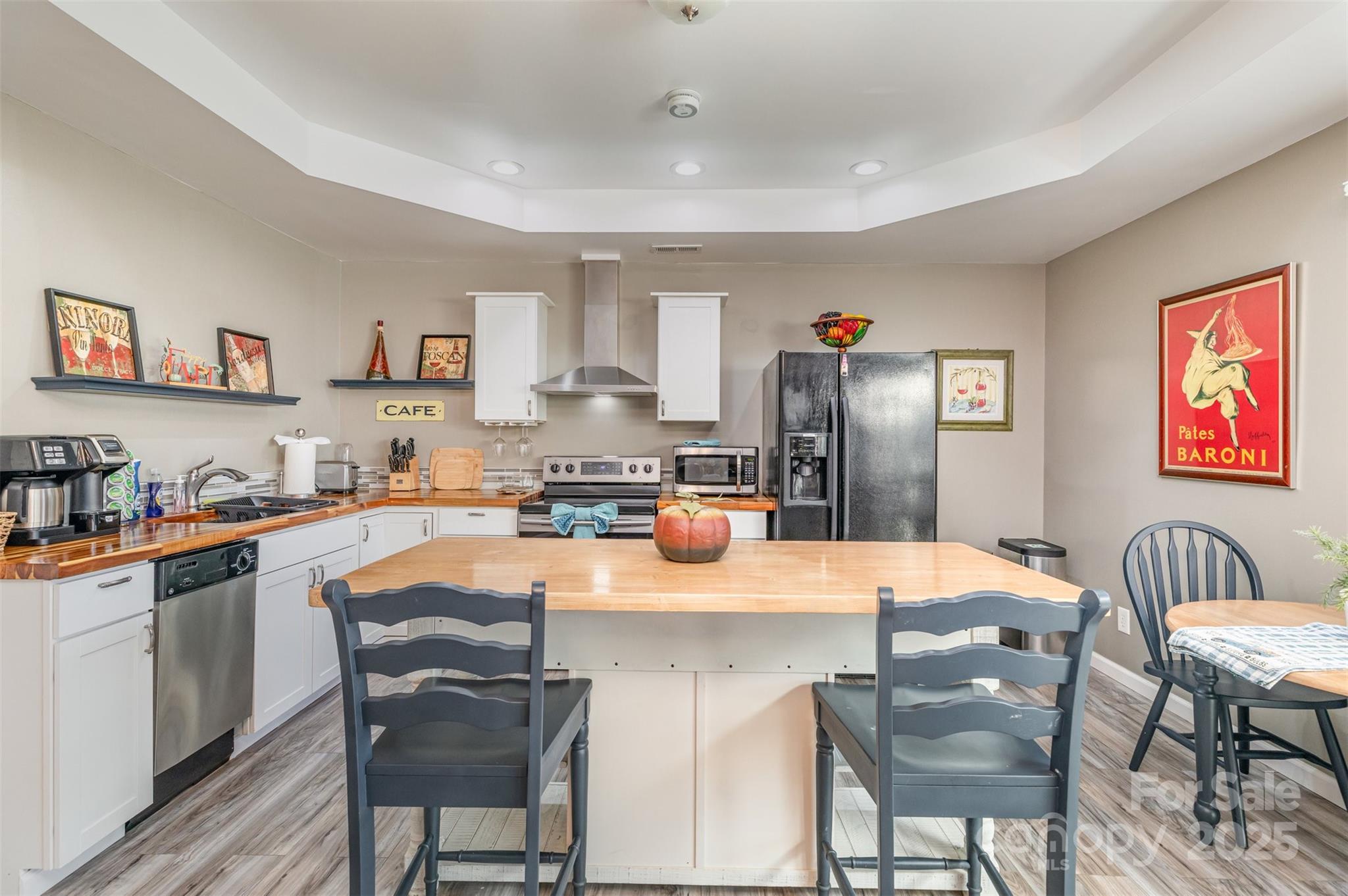 2241 Indian Cross Trail Matthews, NC 28104 - Photo 29 of 46 a kitchen with stainless steel appliances granite countertop a table chairs and a refrigerator