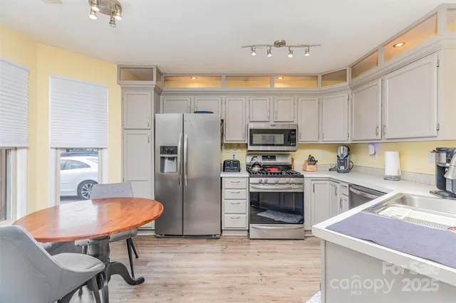 a kitchen with cabinets and stainless steel appliances
