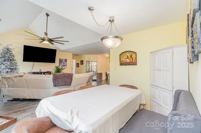 a spacious bedroom with a bed and a flat screen tv