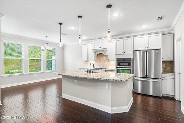 an empty room with a window and a ceiling fan