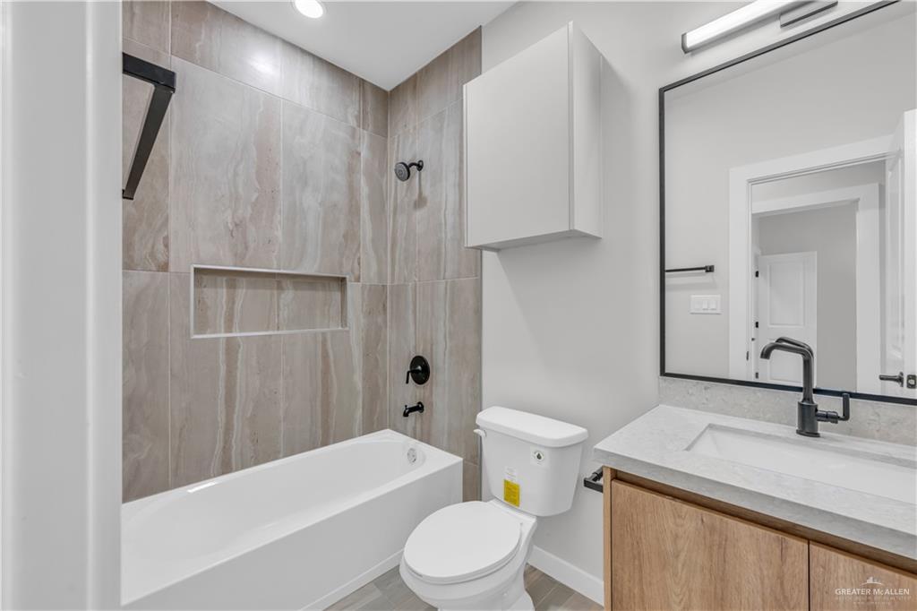 11411 North 24th Lane, Unit B McAllen, TX 78504 - Photo 14 of 24 a bathroom with a sink a toilet and shower