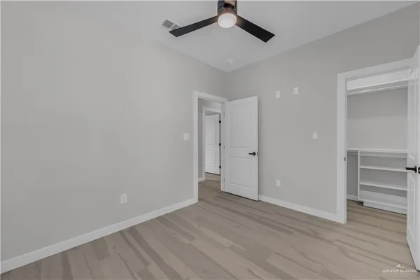 a view of an empty room and wooden floor