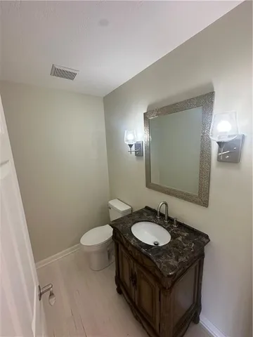 a bathroom with a sink toilet and a mirror