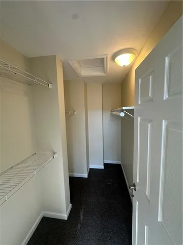 a view of an empty room and a hallway