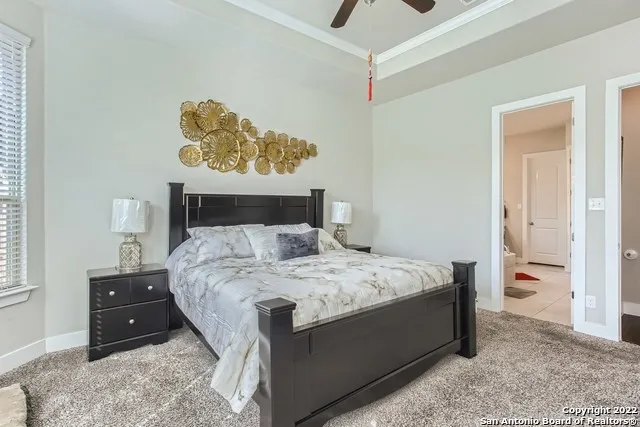 a bedroom with a bed and a painting on the wall