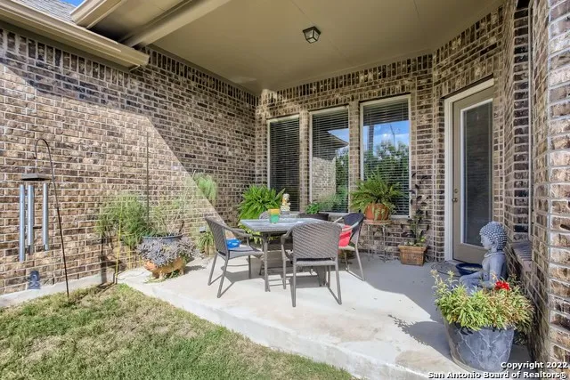 a view of a patio with table and chairs and potted plants
