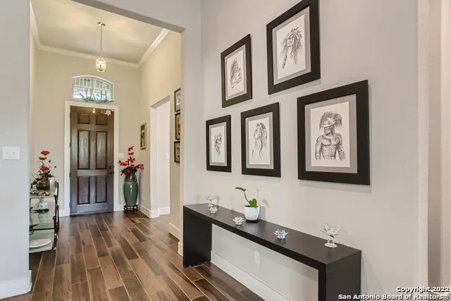 a hallway with wooden floor and furniture