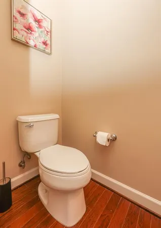 a white toilet sitting next to a small bathroom
