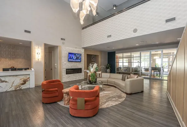 a living room with furniture window and wooden floor