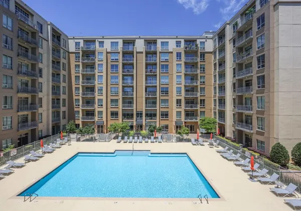 a large building with swimming pool in front of it