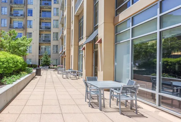 a view of a patio with a table and chairs and potted plants