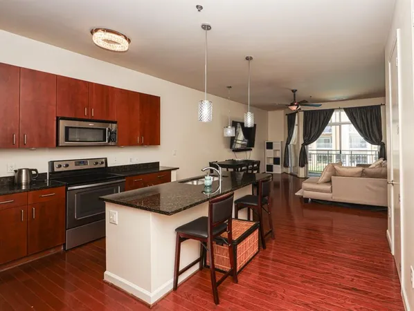 a kitchen with a table chairs sink and cabinets