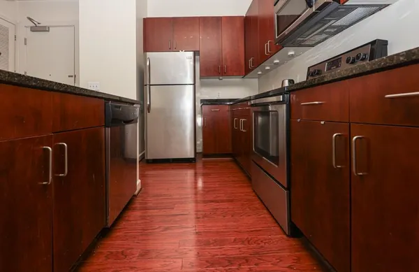 a view of a refrigerator and wooden floor