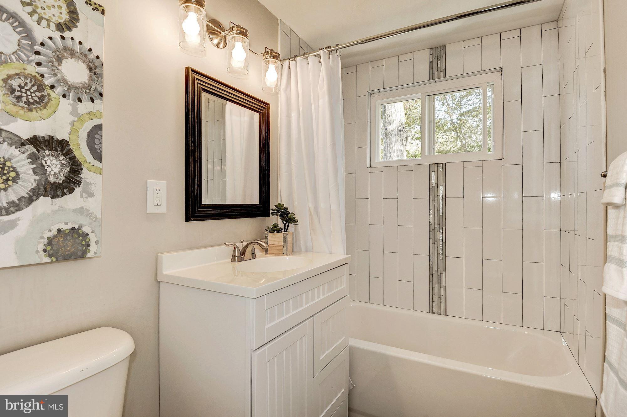 8627 Thames Street Springfield, VA 22151 - Photo 20 of 30 a bathroom with a sink toilet and shower