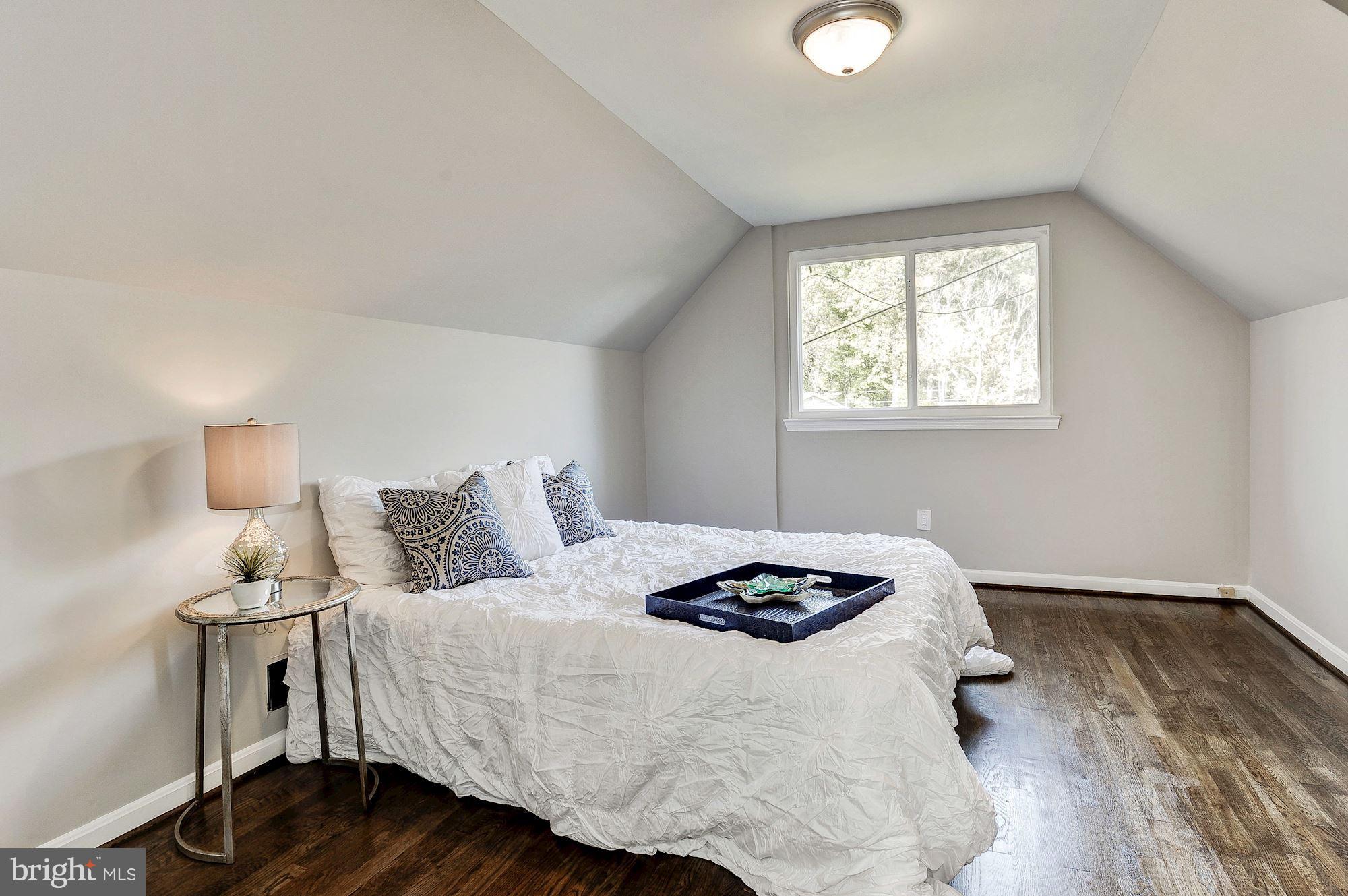 8627 Thames Street Springfield, VA 22151 - Photo 21 of 30 a bedroom with a bed and a window
