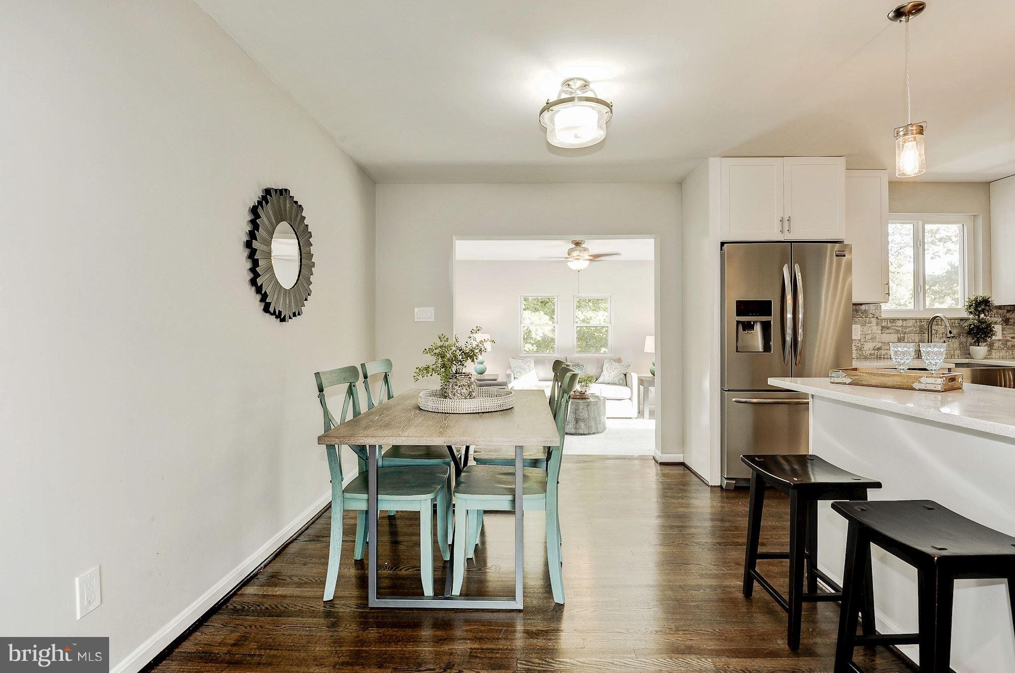8627 Thames Street Springfield, VA 22151 - Photo 7 of 30 a view of a dining room with furniture window and wooden floor