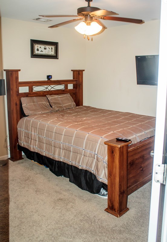 511 Bob White Road Macon, GA 31216 - Photo 17 of 29 a bedroom with a bed and a chandelier