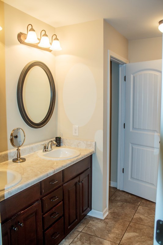 511 Bob White Road Macon, GA 31216 - Photo 20 of 29 a bathroom with a granite countertop double vanity sink and a mirror