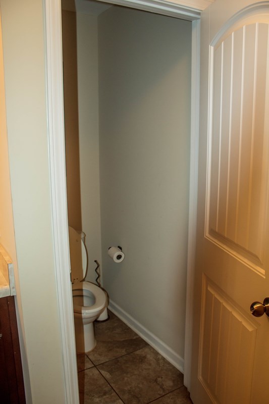 511 Bob White Road Macon, GA 31216 - Photo 22 of 29 a bathroom with a granite countertop toilet and a sink