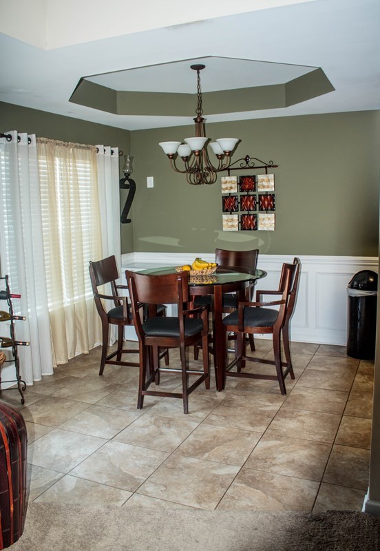 511 Bob White Road Macon, GA 31216 - Photo 8 of 29 a view of a dining room with furniture and a chandelier