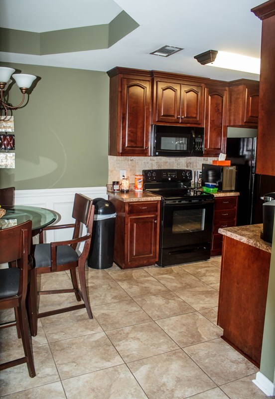 511 Bob White Road Macon, GA 31216 - Photo 9 of 29 a kitchen with stainless steel appliances granite countertop a stove top oven a sink a counter top space and cabinets