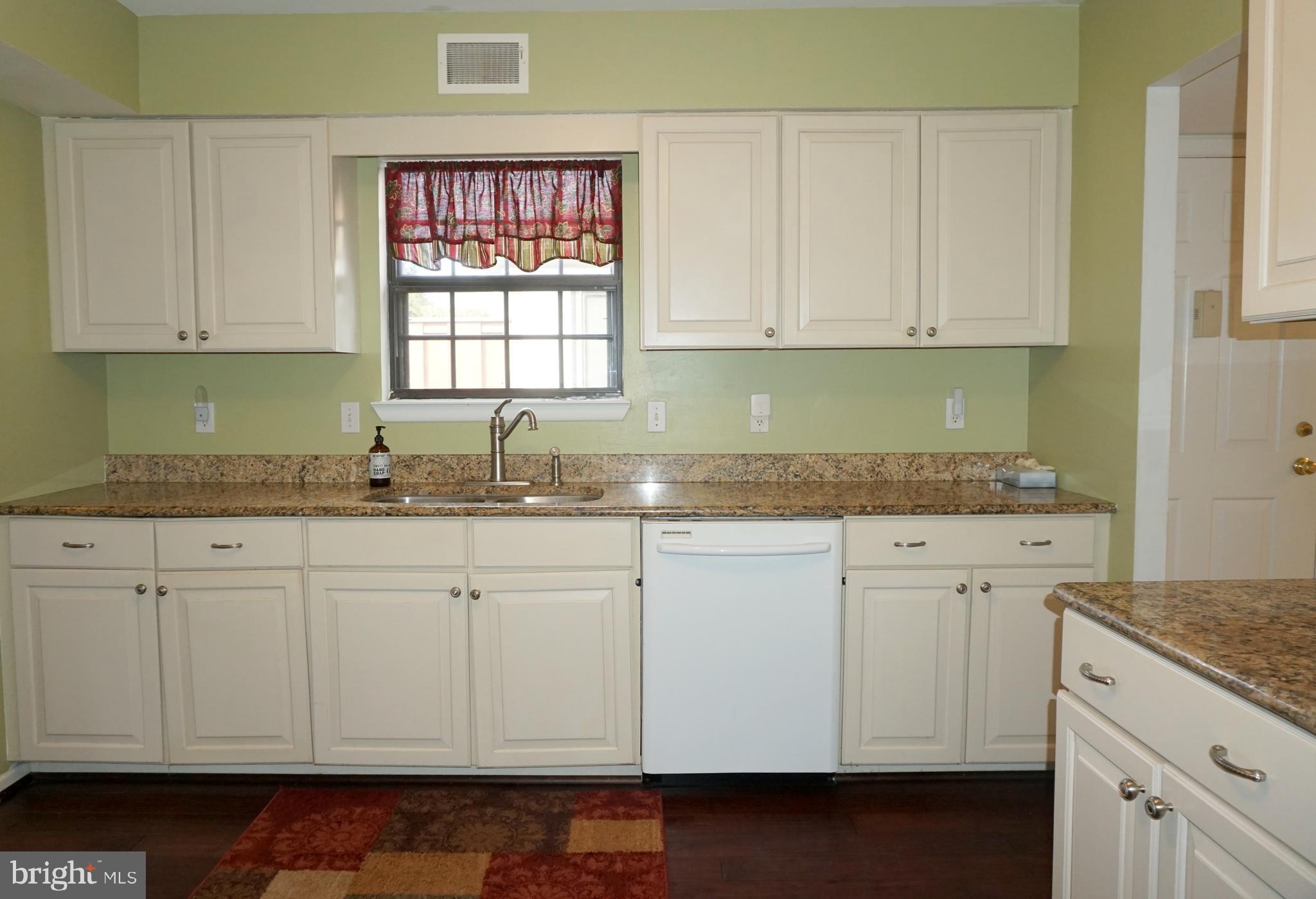 2834 Springhaven Place Macungie, PA 18062 - Photo 5 of 19 a kitchen with granite countertop white cabinets and white appliances