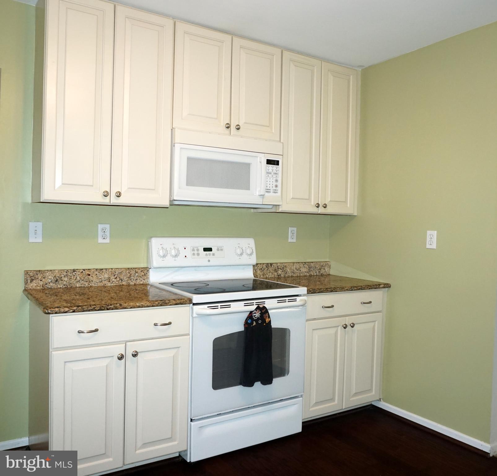 2834 Springhaven Place Macungie, PA 18062 - Photo 6 of 19 a kitchen with granite countertop white cabinets and white appliances