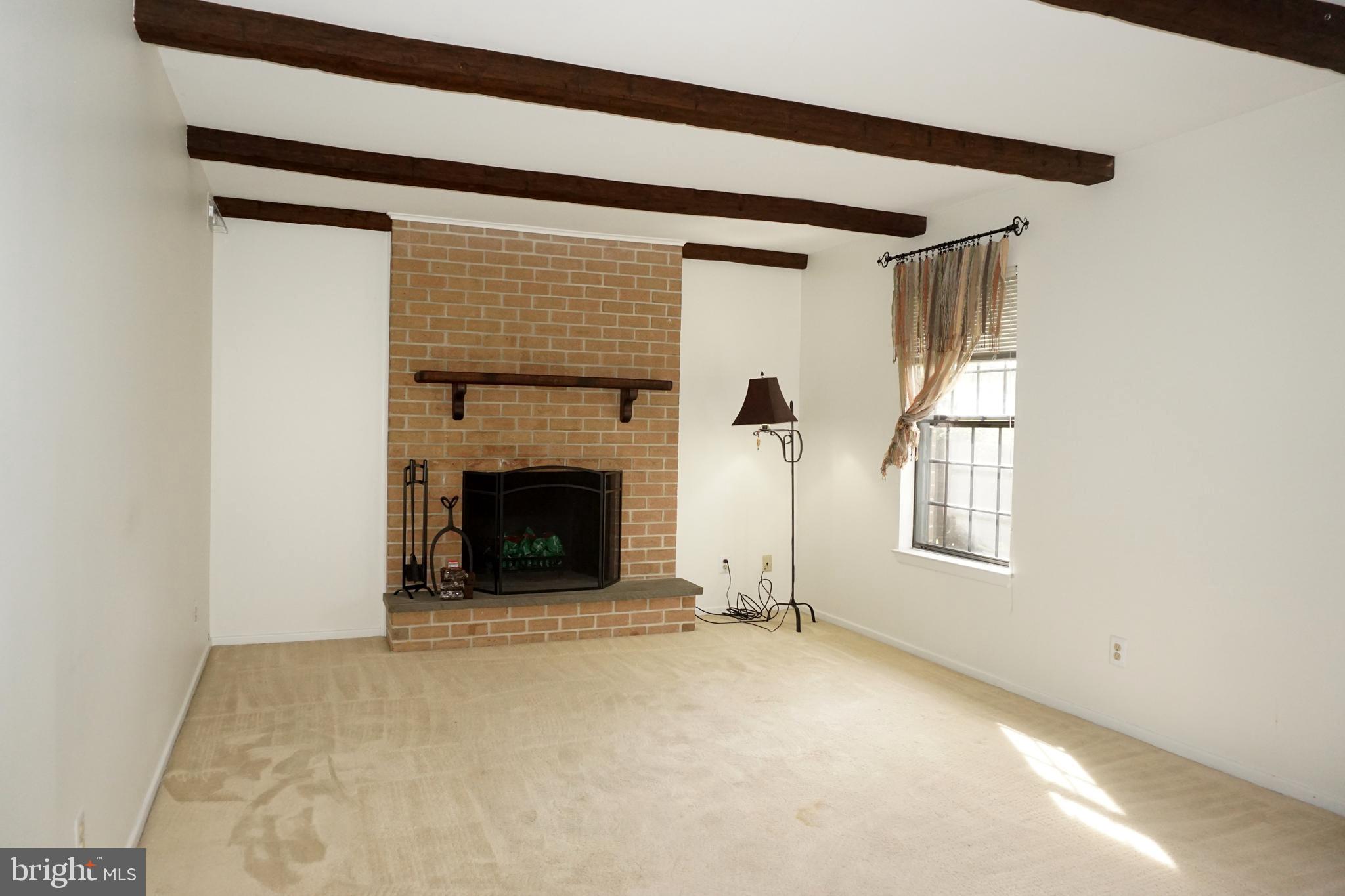 2834 Springhaven Place Macungie, PA 18062 - Photo 8 of 19 a view of an empty room with a fireplace and a window