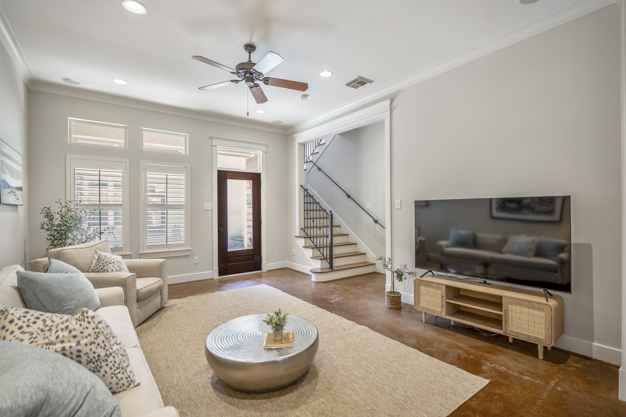 905 West 23rd Street Houston, TX 77008 - Photo 5 of 46 Open-concept first-floor living with soaring ceilings, fresh interior paint, and durable concrete flooring for a modern, low-maintenance feel.