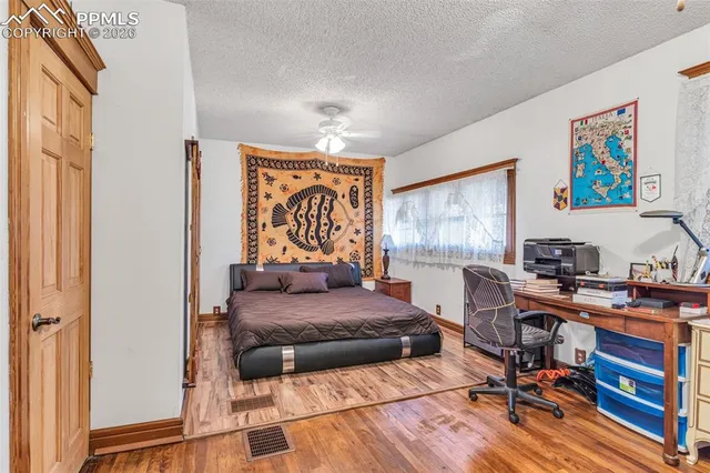 a bedroom with a bed and a desk