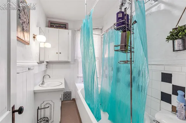 a bathroom with a sink and mirror