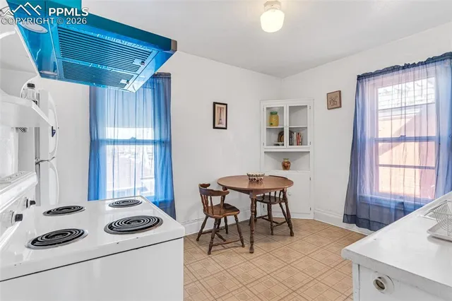 a kitchen with a stove and white cabinets