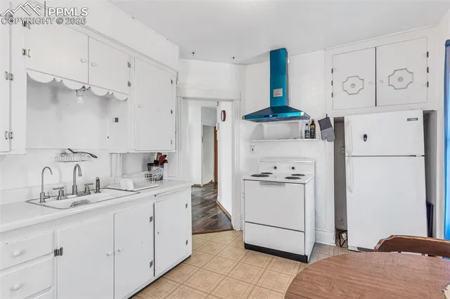 a kitchen with stainless steel appliances a refrigerator sink and cabinets