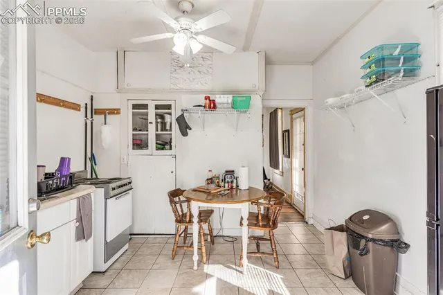 a kitchen with a refrigerator and white cabinets