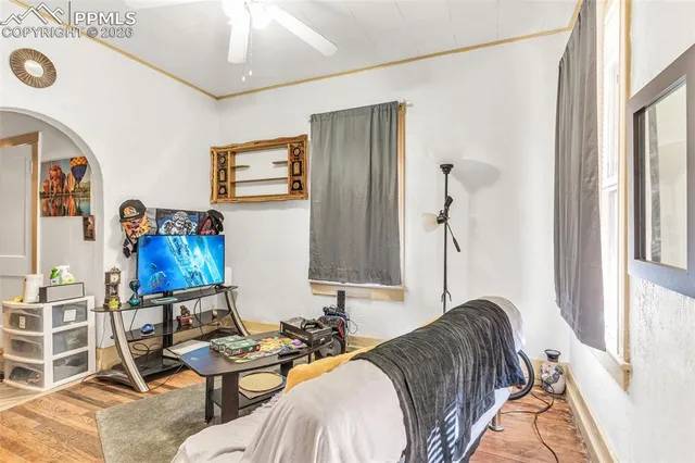 a living room with furniture and wooden floor