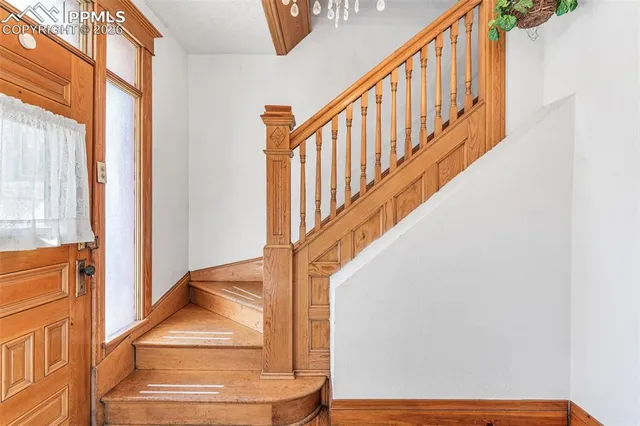 a view of staircase with railing and a window