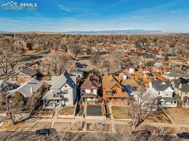 an aerial view of residential houses with outdoor space