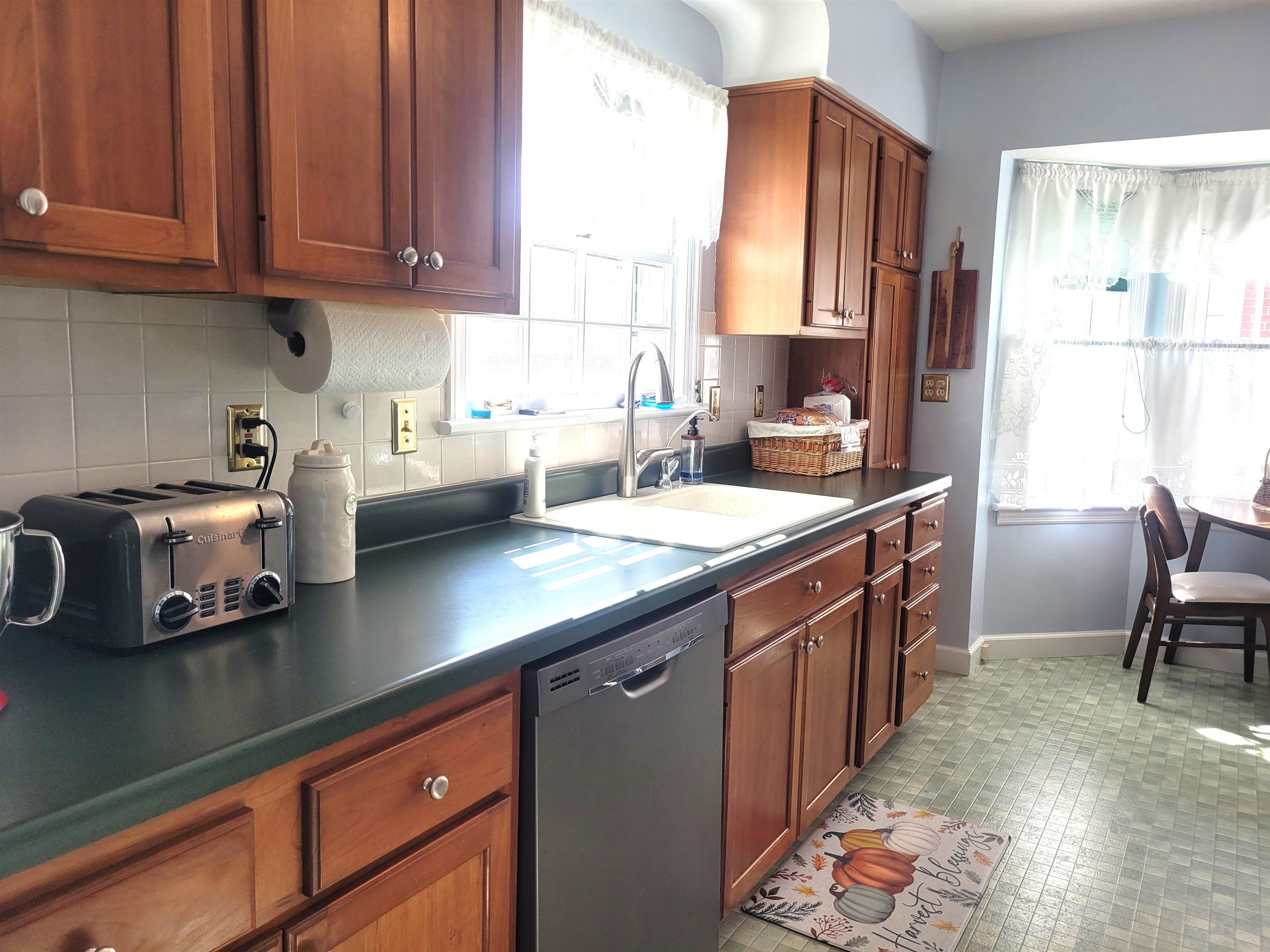 509 West 14th Street Sterling, IL 61081 - Photo 31 of 70 a kitchen with stainless steel appliances granite countertop a sink stove and cabinets