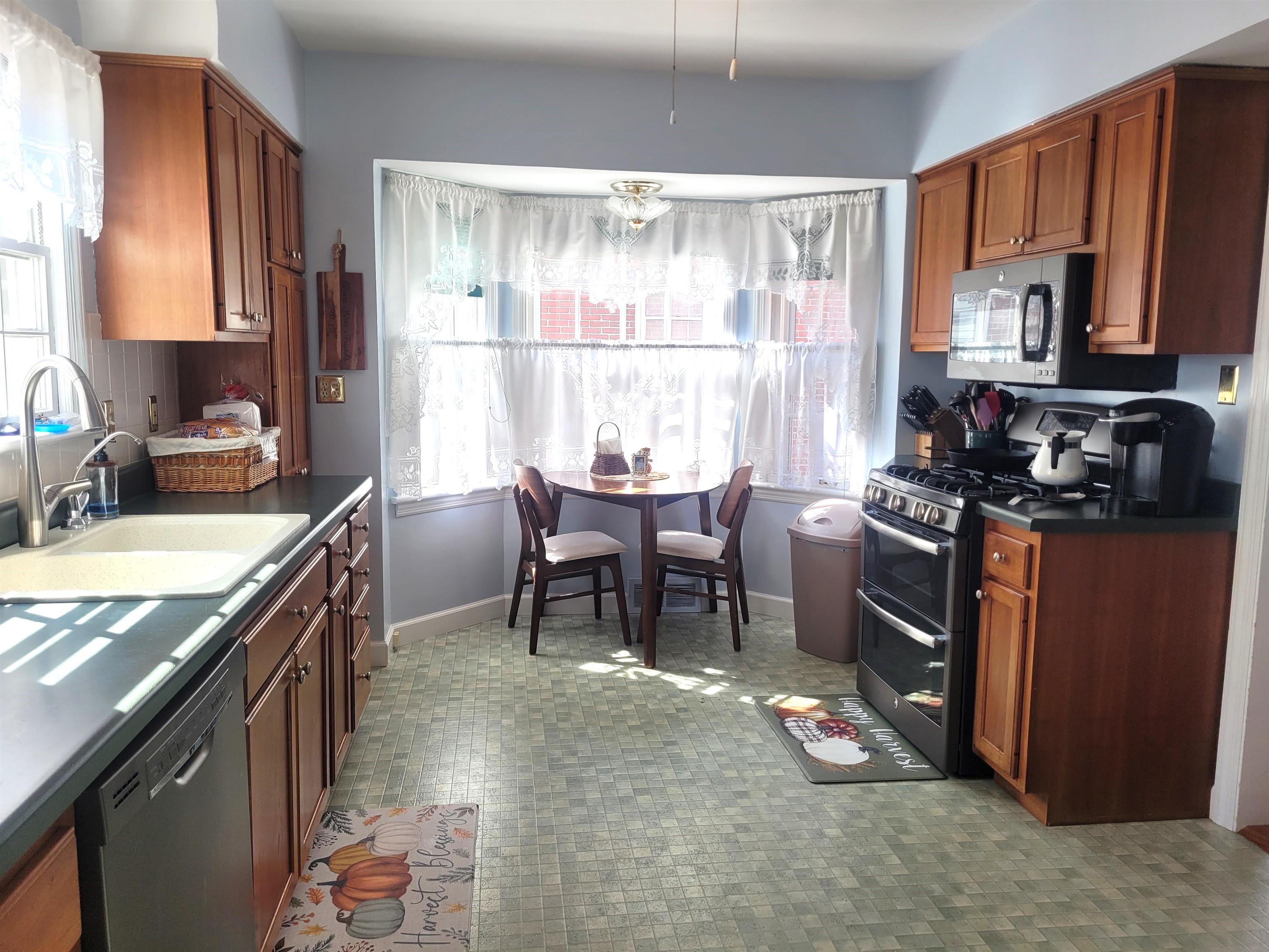 509 West 14th Street Sterling, IL 61081 - Photo 32 of 70 a kitchen with a stove a sink and a refrigerator
