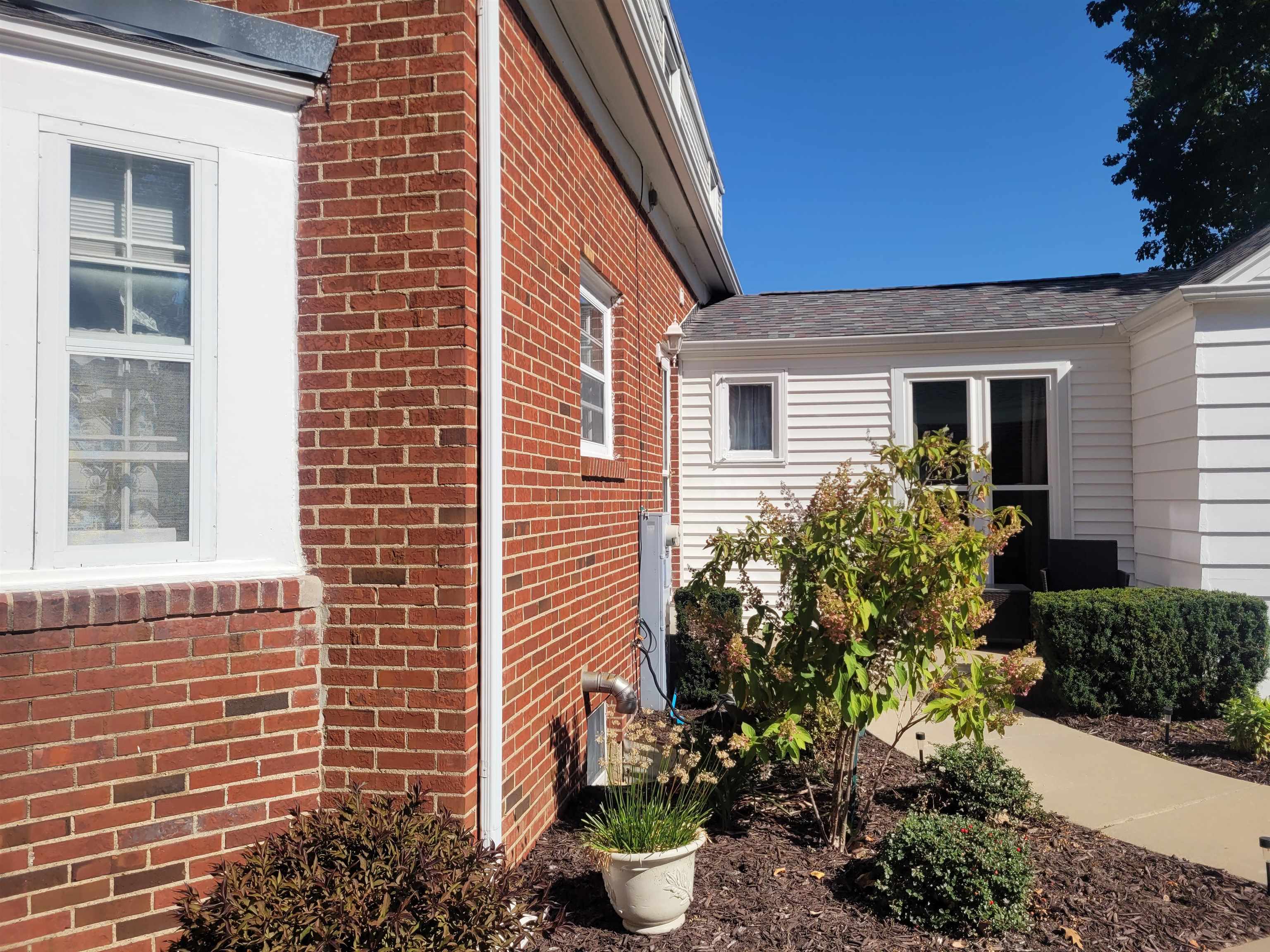 509 West 14th Street Sterling, IL 61081 - Photo 6 of 70 a view of a backyard with plants and chair