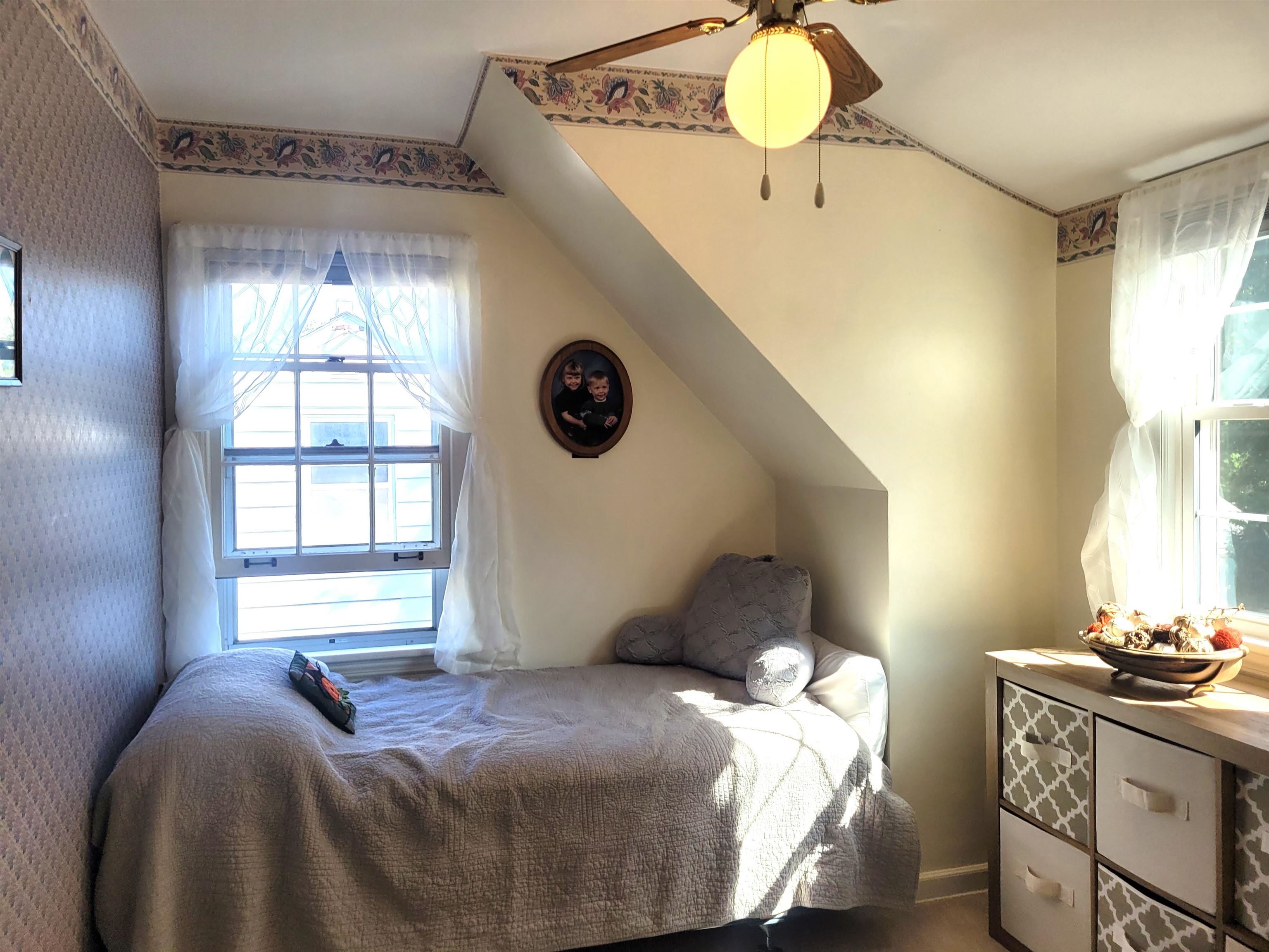 509 West 14th Street Sterling, IL 61081 - Photo 62 of 70 a bedroom with a bed and a chandelier