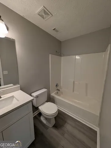 a bathroom with a toilet a sink and bathtub