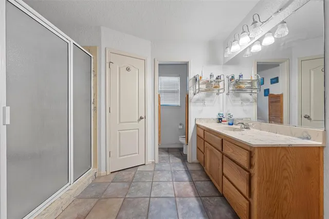 a bathroom with a sink mirror and a shower