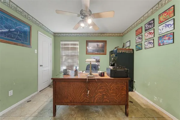a room with stainless steel appliances kitchen island granite countertop furniture a rug and a window
