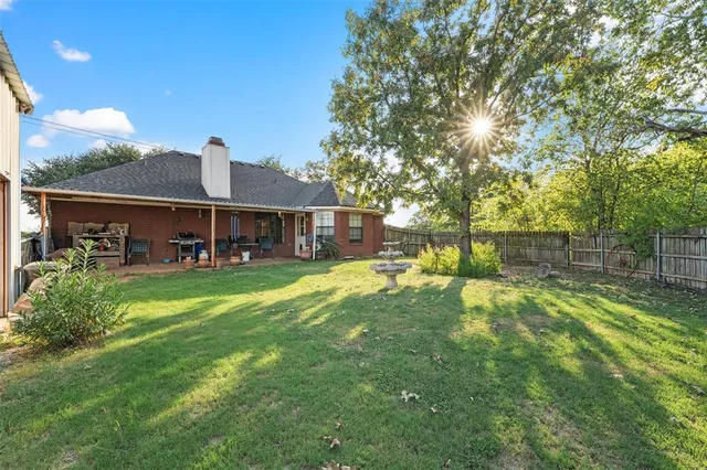 a view of a house with a yard porch and sitting area