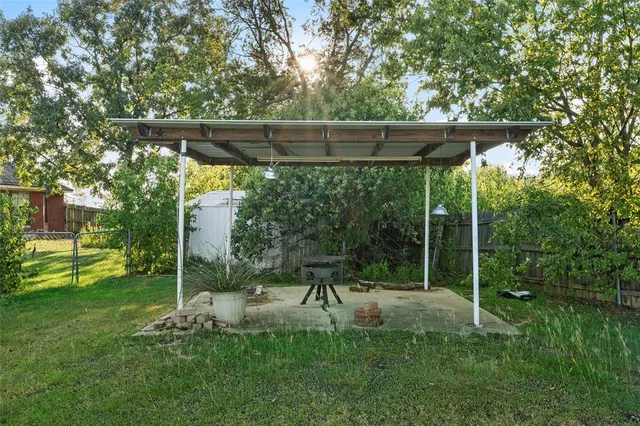 a view of a chair and table in the garden