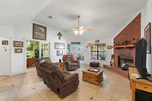 a living room with furniture a flat screen tv and a fireplace